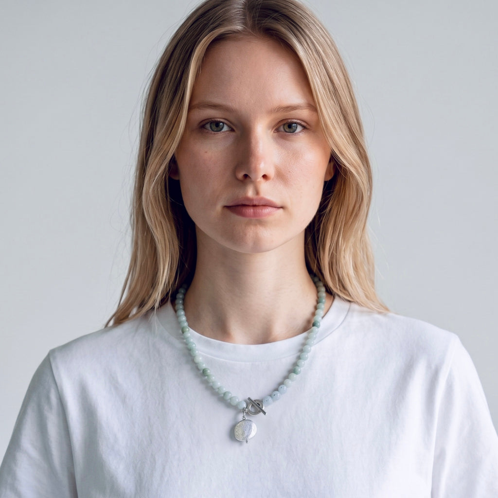 Model wearing the Neptune aquamarine and freshwater coin pearl sterling silver necklace